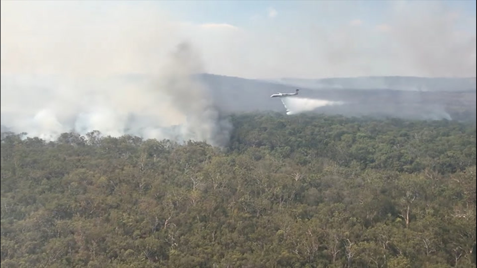 A large air tanker dropped fire suppressant to support fire crews on the ground battling a bush fire on Fraser Island, Queensland, on Nov. 22.