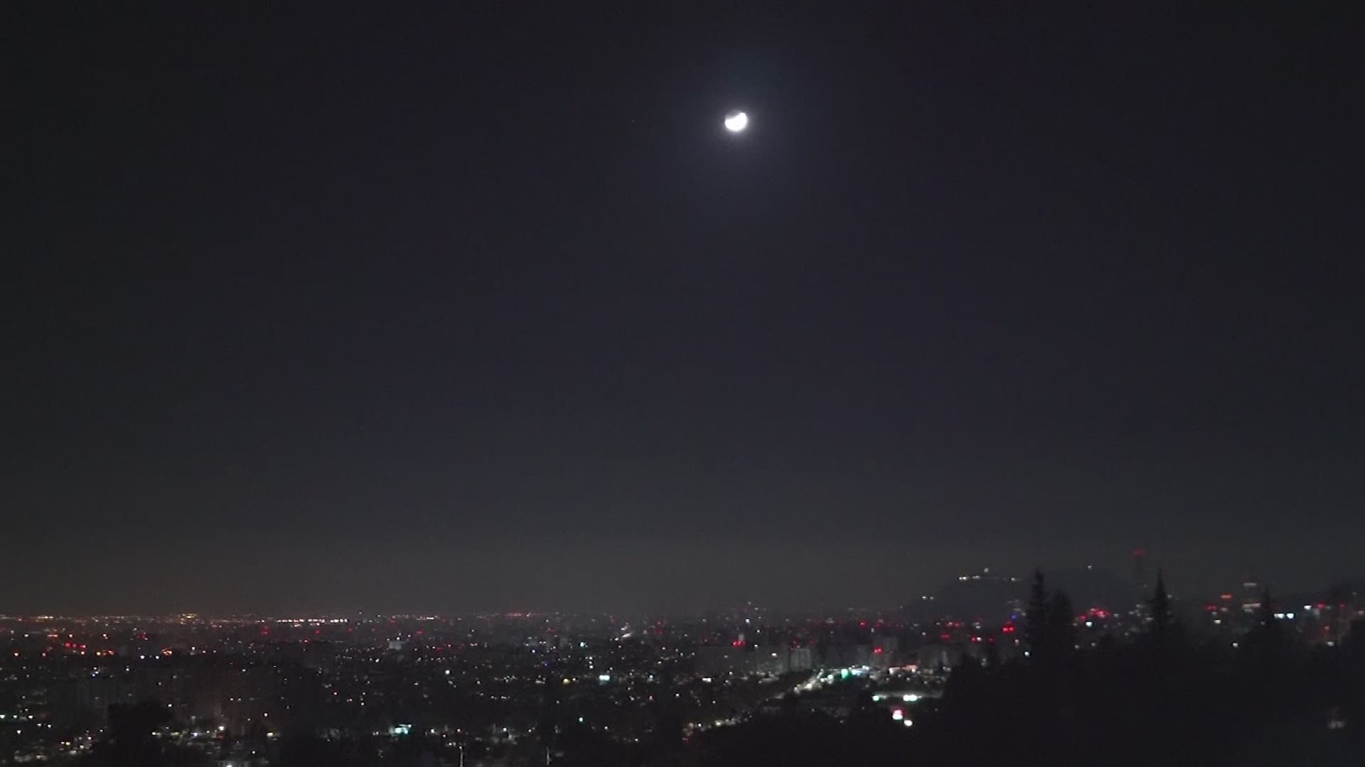 Earth's shadow crept across the moon on Wednesday as people in Chile and around the world waited for a cosmic event known as a super blood moon. (AP)