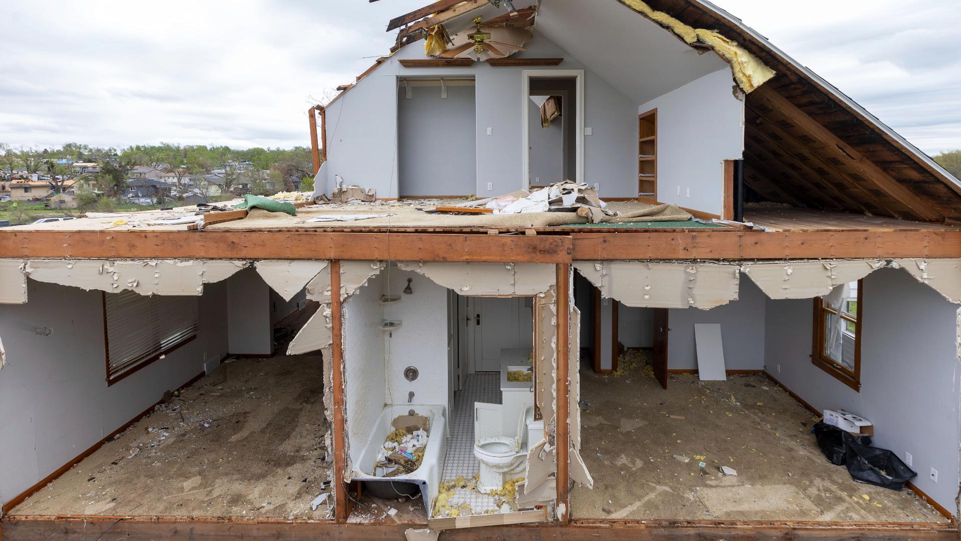 A tornado on Friday plowed through suburban Omaha, Nebraska, demolishing homes and businesses as it tore for miles along farmland and into subdivisions.