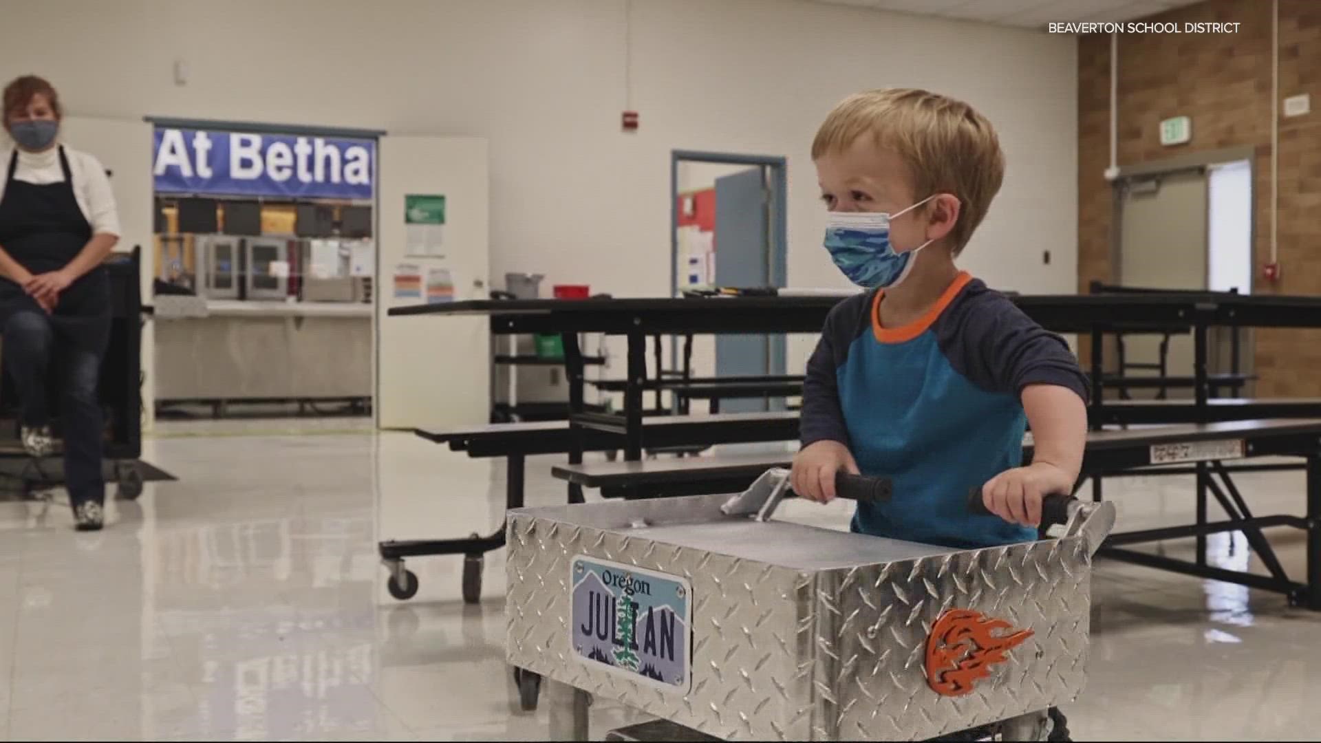Six-year-old Julian needs accommodations to help him get his lunch. When a worker saw the cart he was using, she had her husband craft him something so  much better.