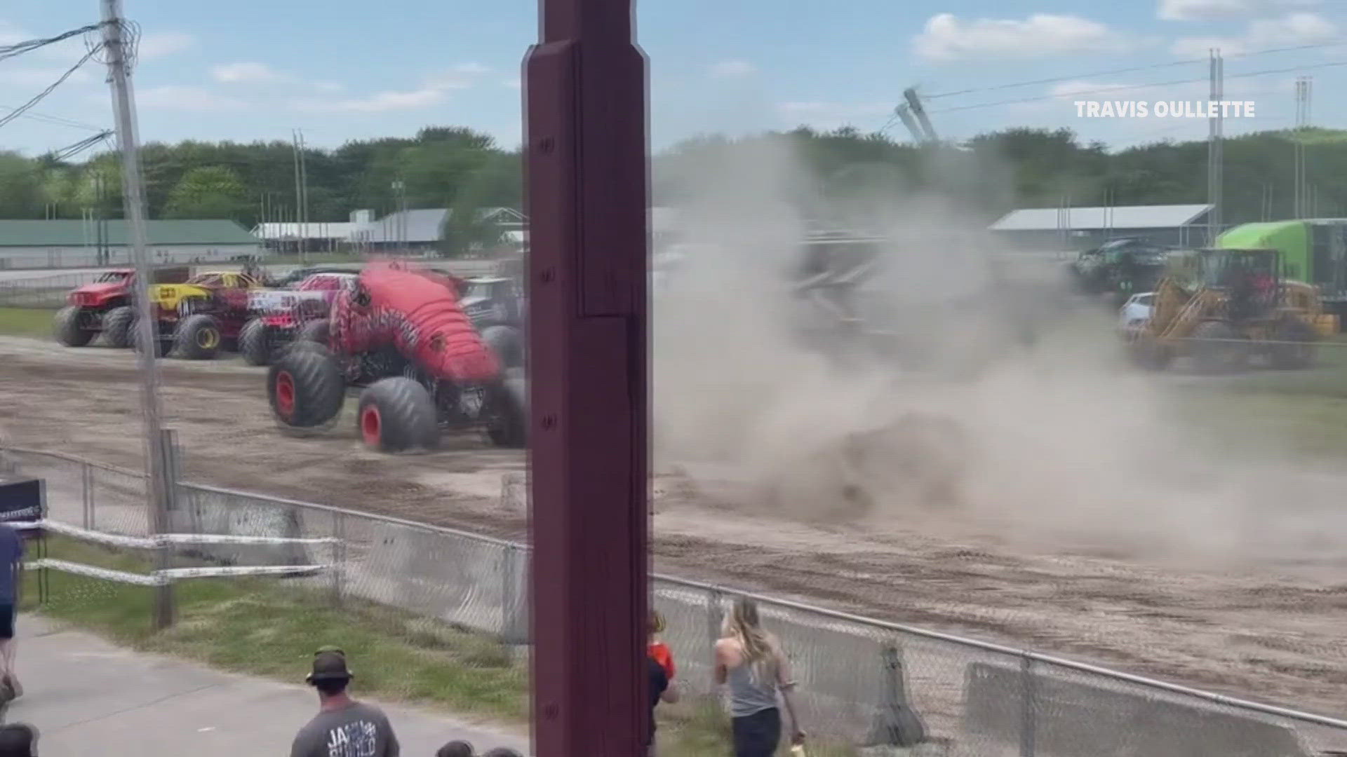 A monster truck went over a jump and hit an aerial utility wire that was across the race track. The wire got stuck on the truck, pulling down several utility poles.