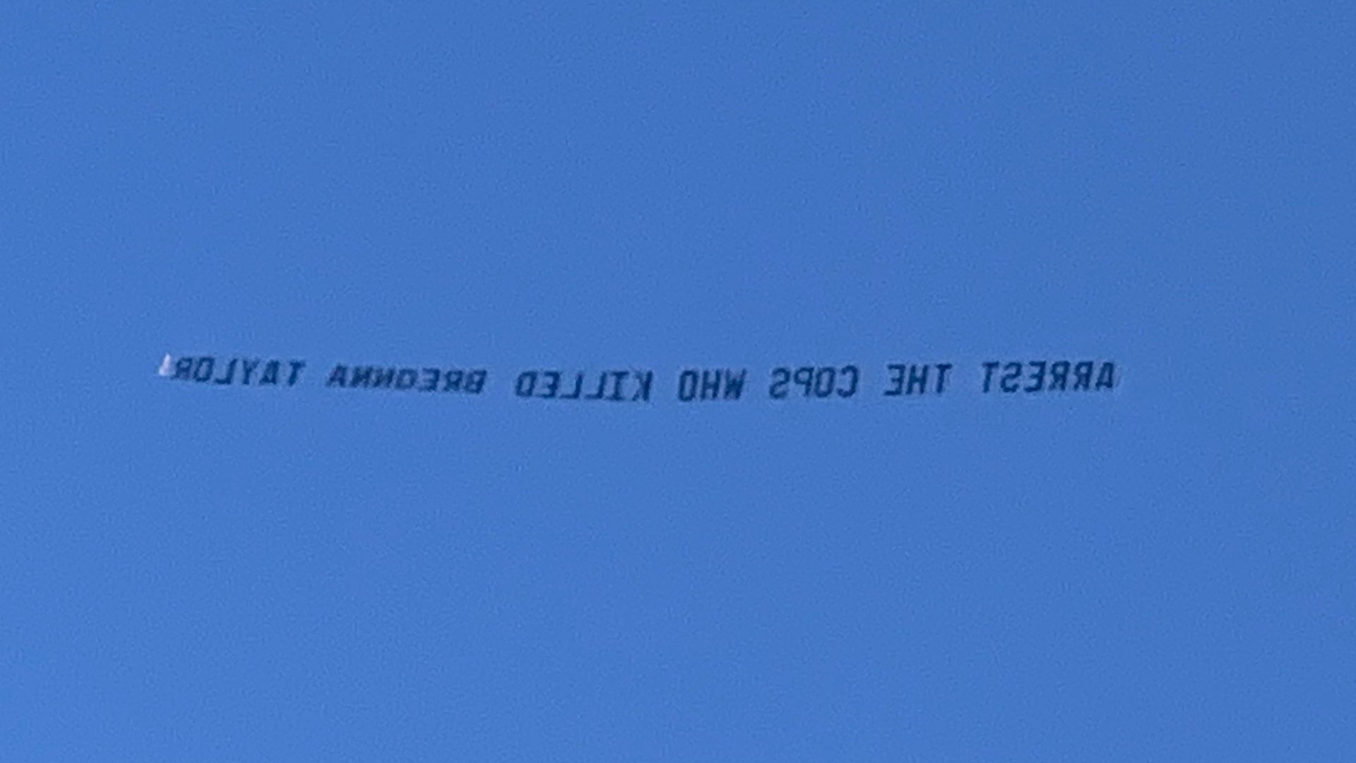 A banner saying "Arrest the cops that killed Breonna Taylor flew over Churchill Downs ahead of the Kentucky Derby race.