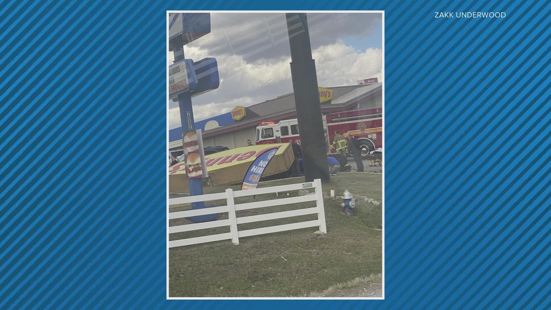 One woman died and two people were injured after the sign fell on a car in the restaurant parking lot.