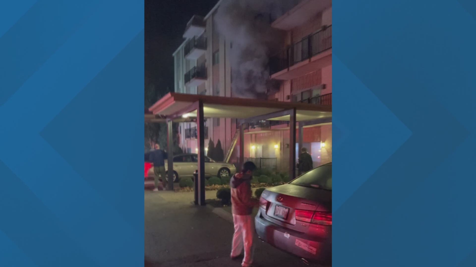 Dark smoke billows out of the front of a condo in Louisville during an overnight fire.