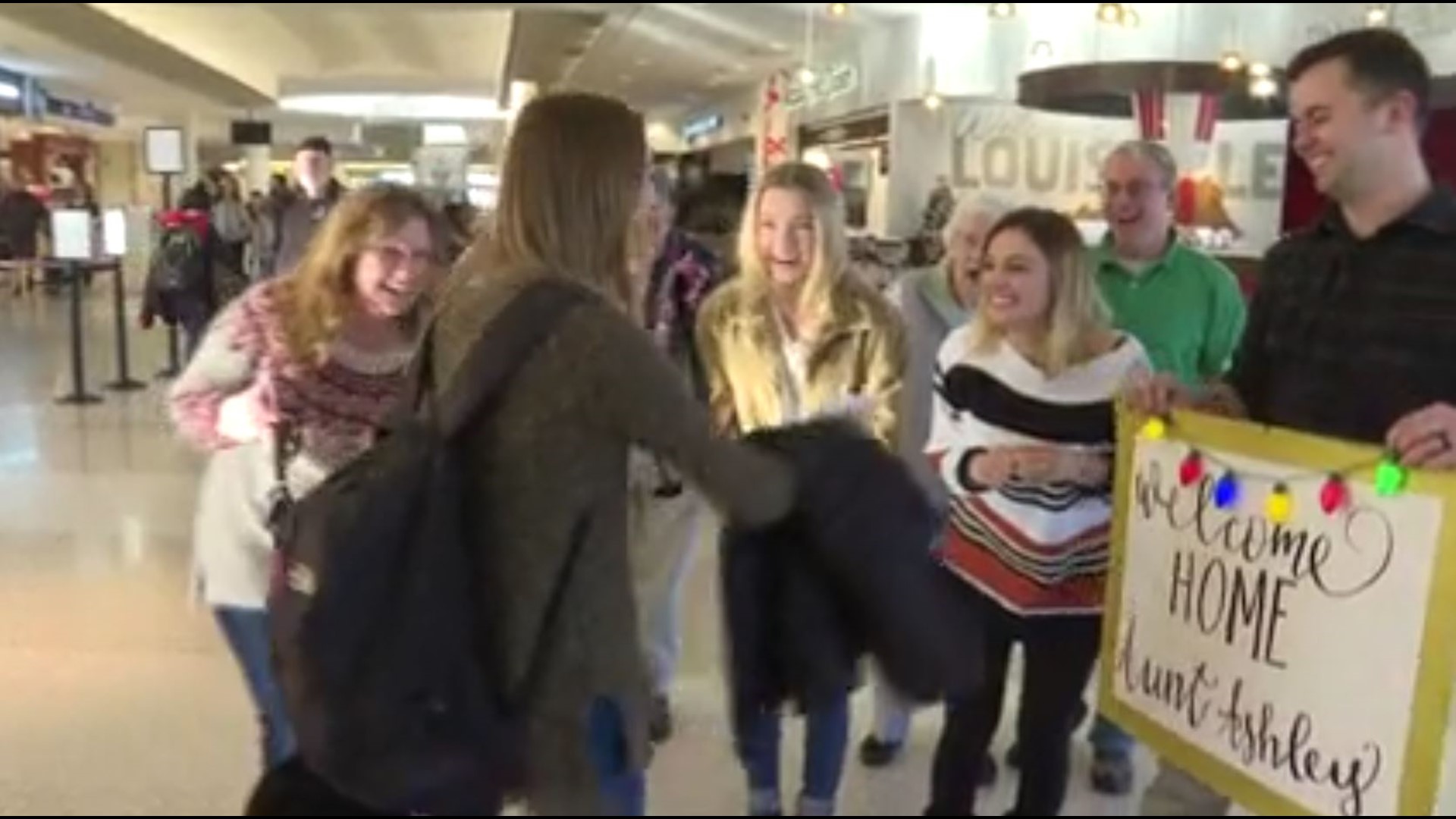 A woman returning home for the holidays was surprised at the airport with news that shes going to be an aunt.