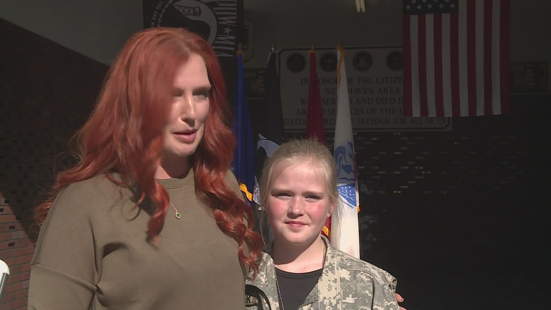 Amy Spalding was featured alongside her daughter as they walked the Army Branch's flag in front of their neighbors.