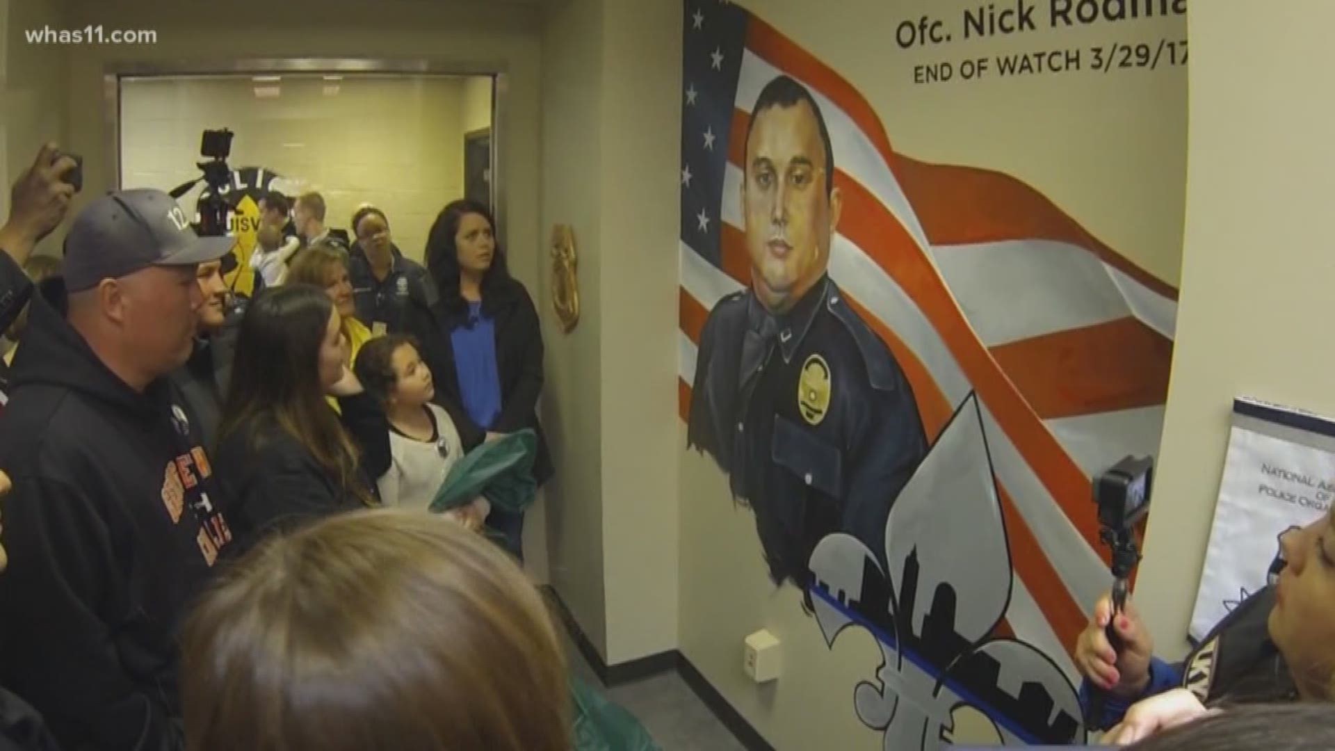The city honored fallen Officer Nick Rodman with a street naming and mural.