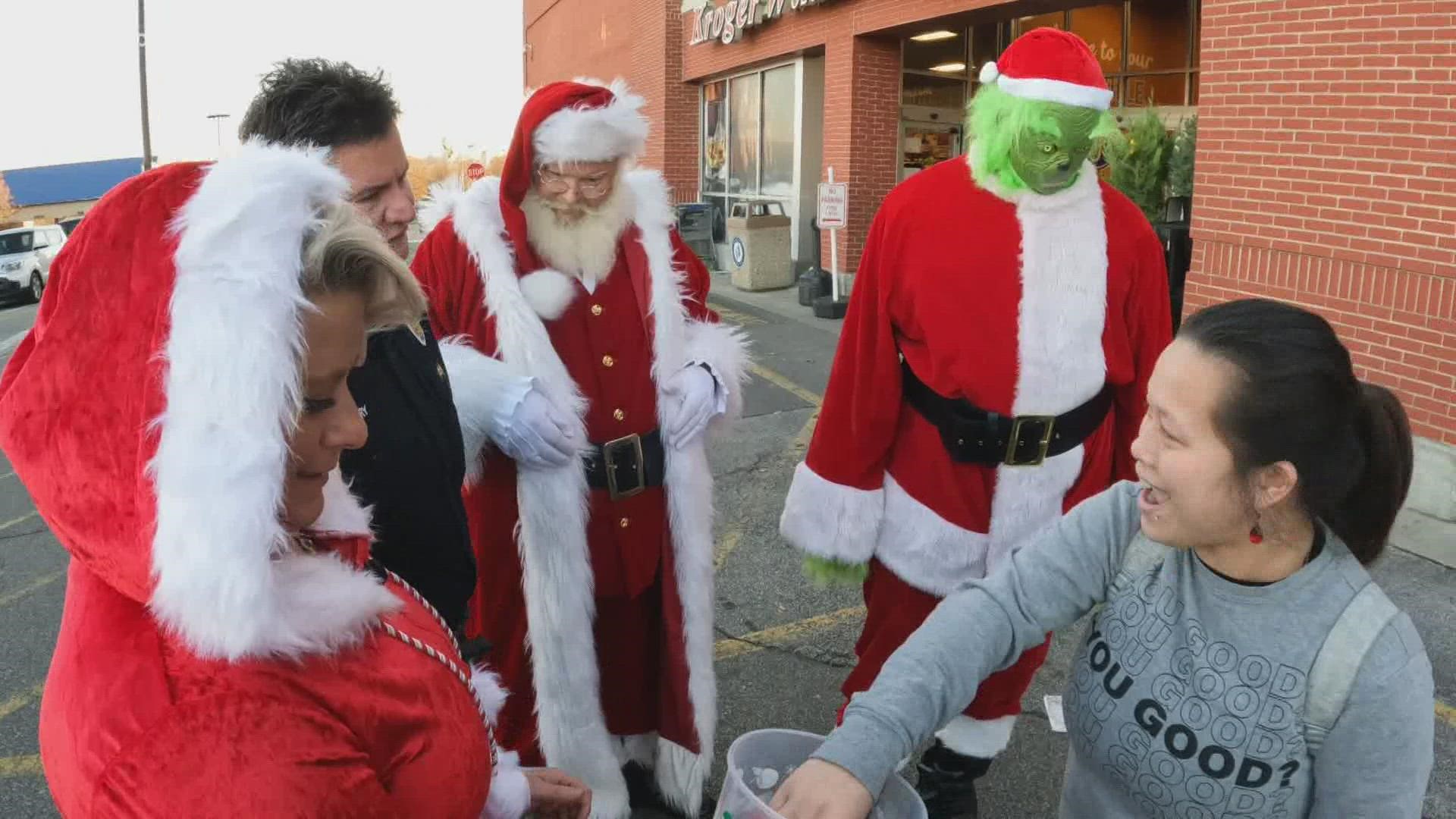 Louisville Police and Santa hand out Kroger gift cards to members of the community as part of their 'Santa Stops' series.