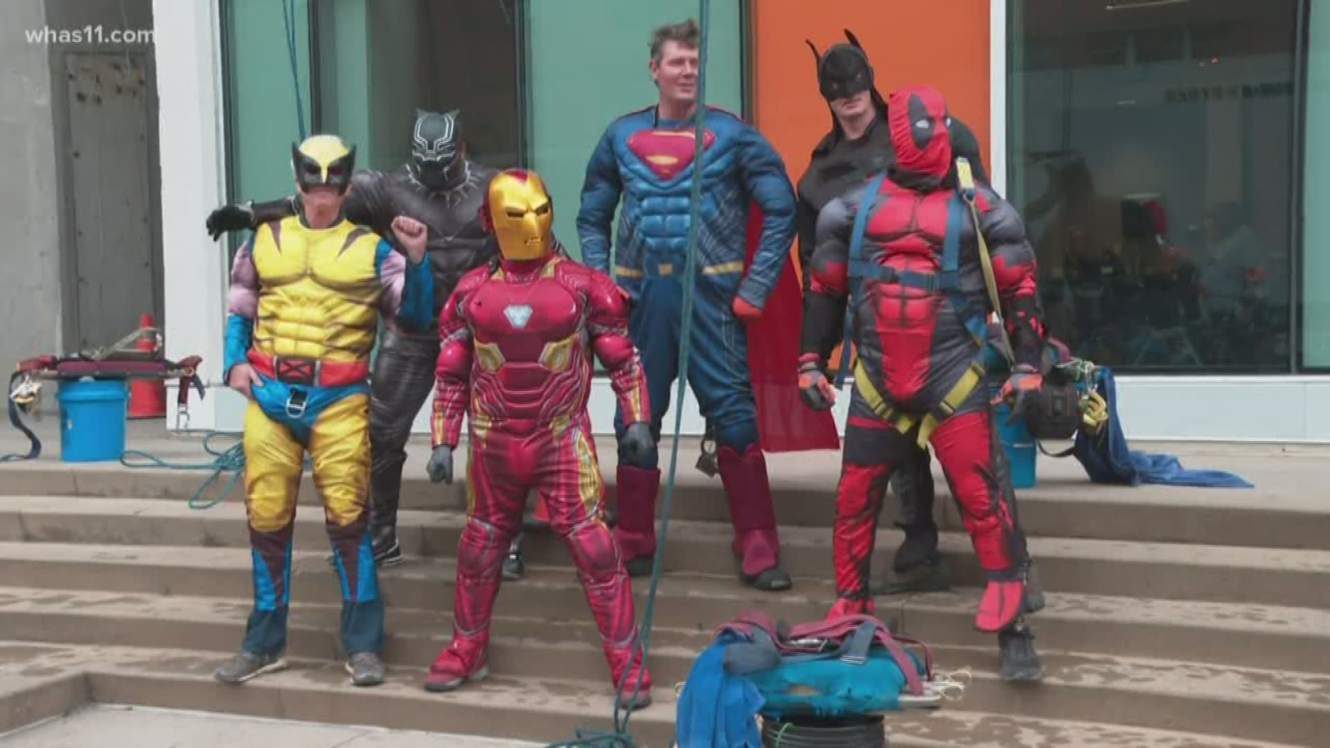 The crew from Pro Clean International put on Superman, Black Panther and Batman costumes at 9 a.m. as they scaled the hospital walls.