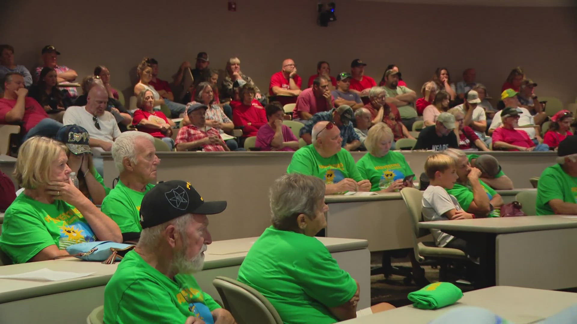 The energy company, Orion Renewables, addressed the Board of Zoning Appeals in a room full of people dressed in red and green.