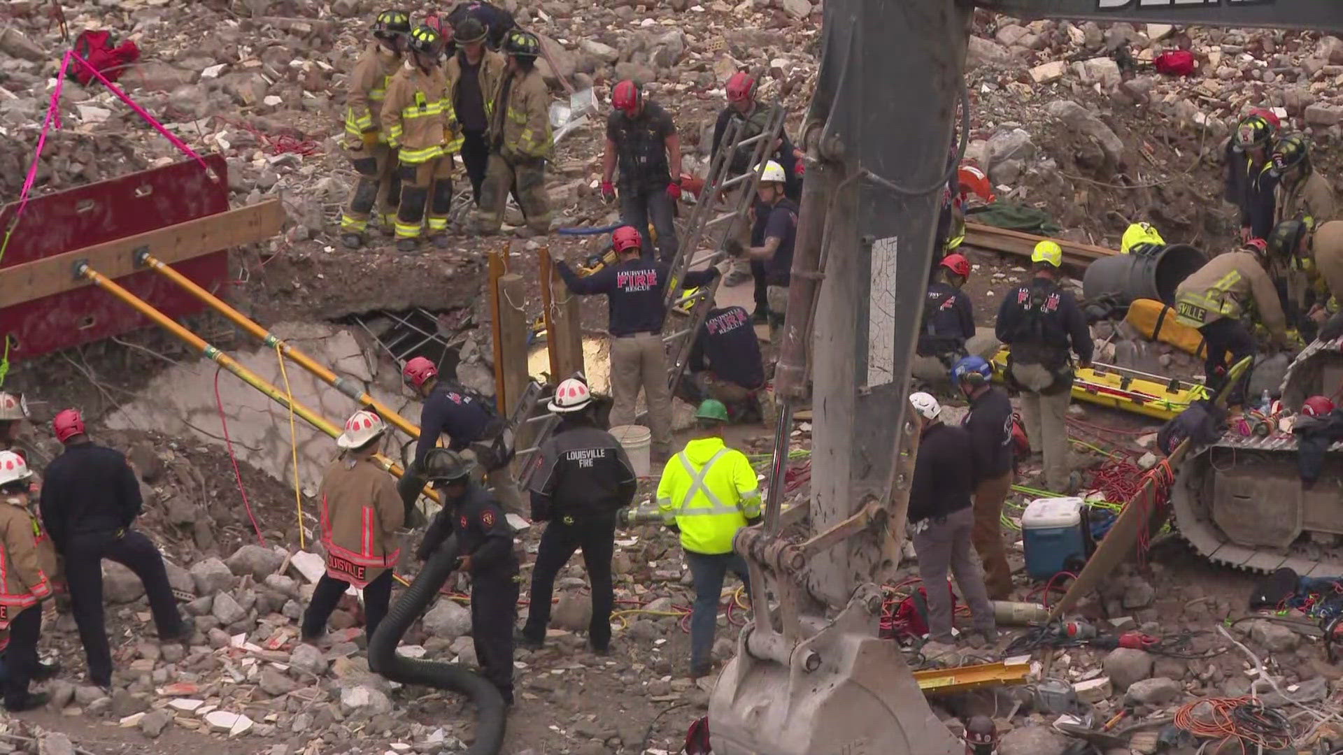 Louisville firefighters move slow and steady as the worker has been stuck underground for several hours.