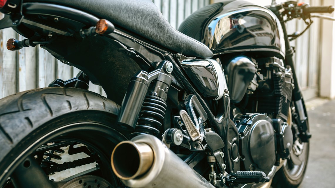 What causes a motorcycle to backfire?
