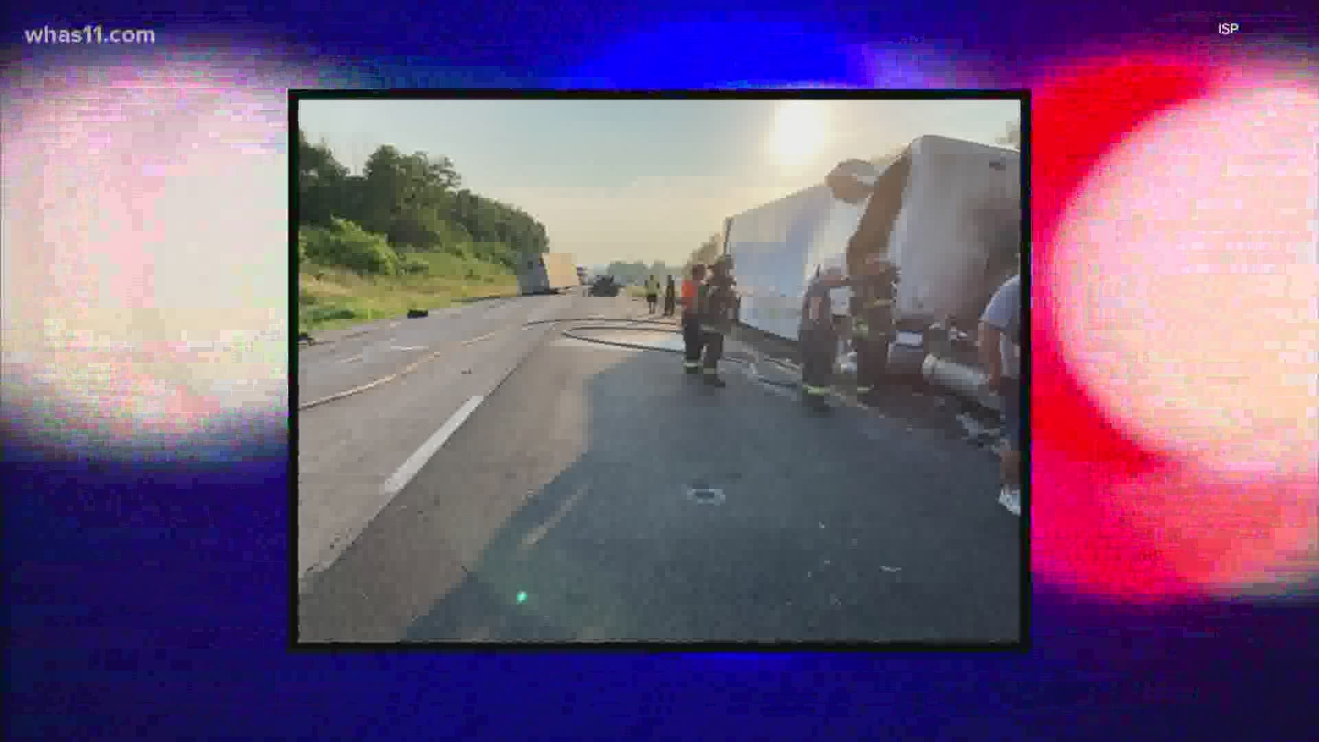 All four passengers were killed when police say a semi slammed into the back of their car and pushed it under a semi that was in front of them.