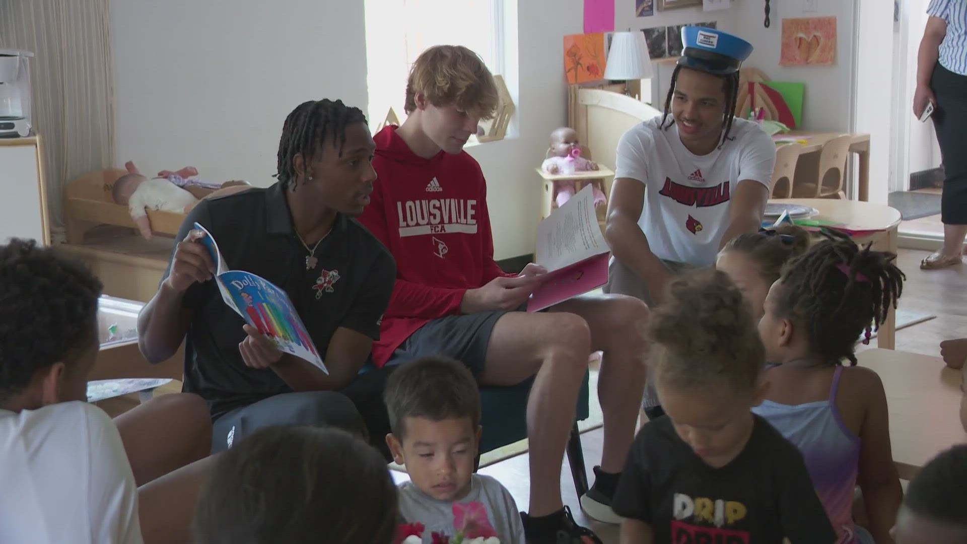 University of Louisville basketball players read books to children