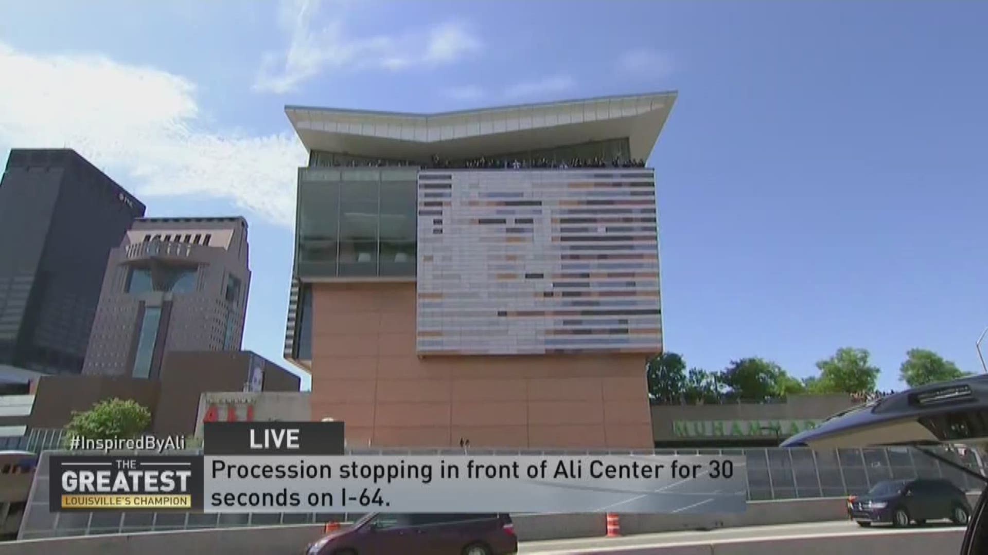 Ali procession stops at Ali Center in front of chanting crowds