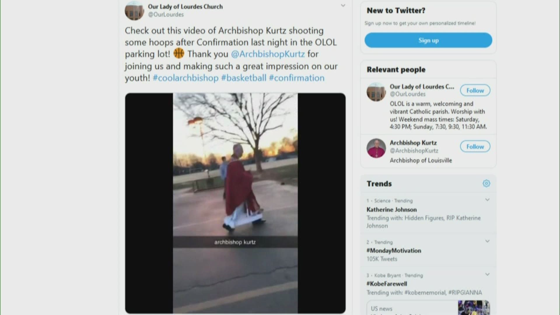 Archbishop Kurtz didn't let his formal attire get in the way of taking some shots with kids in the parking lot of Our Lady of Lourdes Church.
