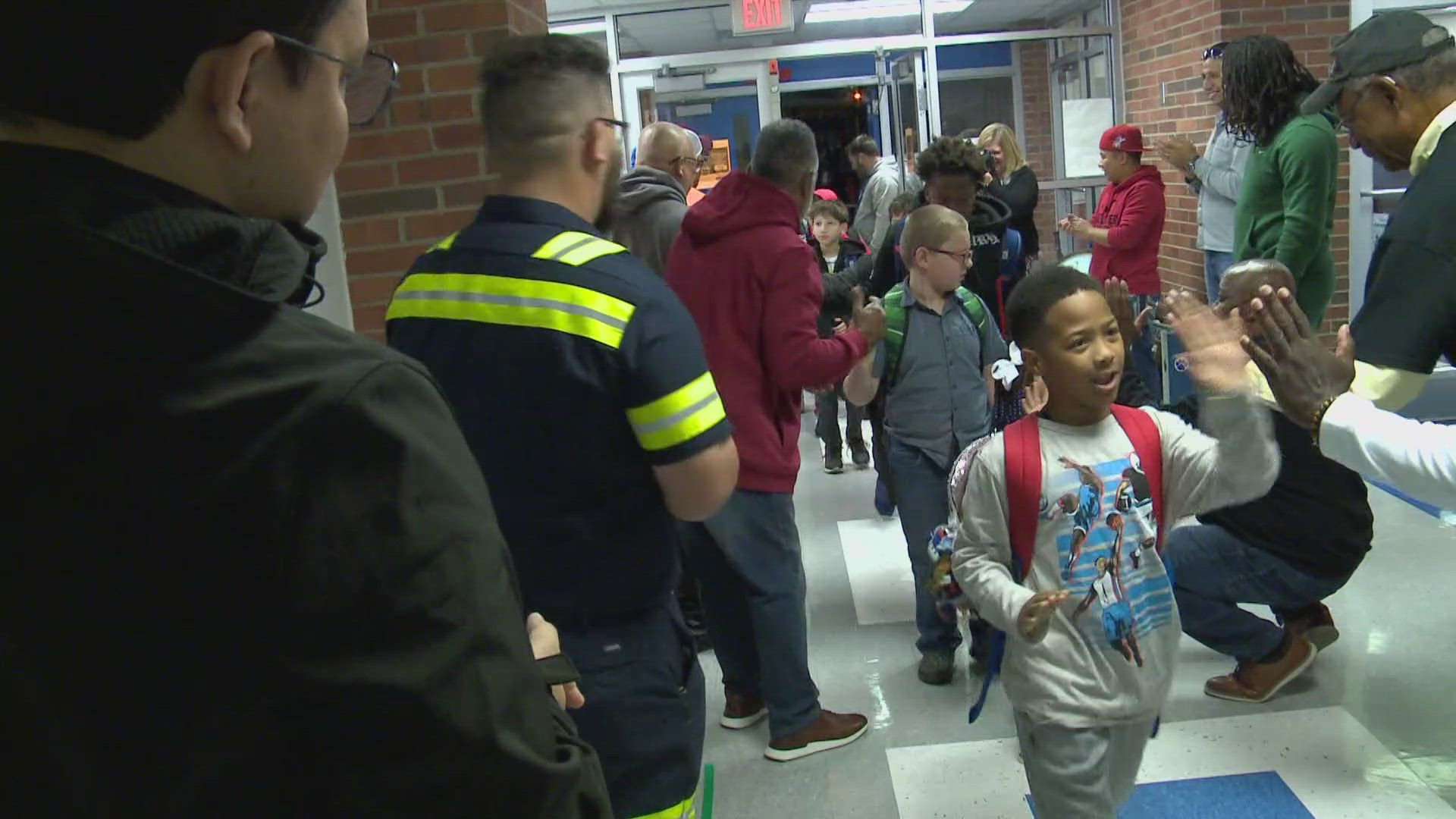 They greeted the students at Camp Taylor Elementary with cheers and high fives.