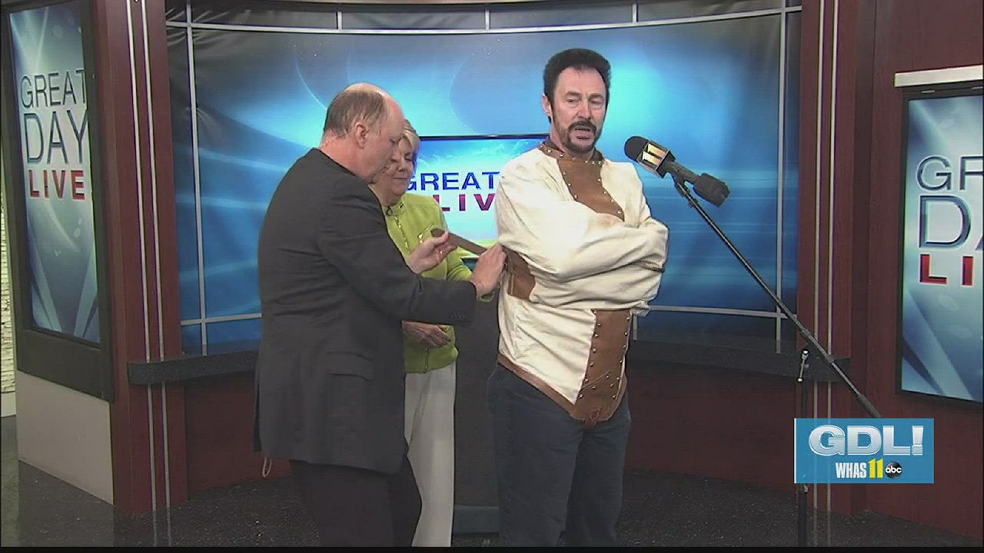 Terry Meiners puts Lance Burton in a straitjacket
