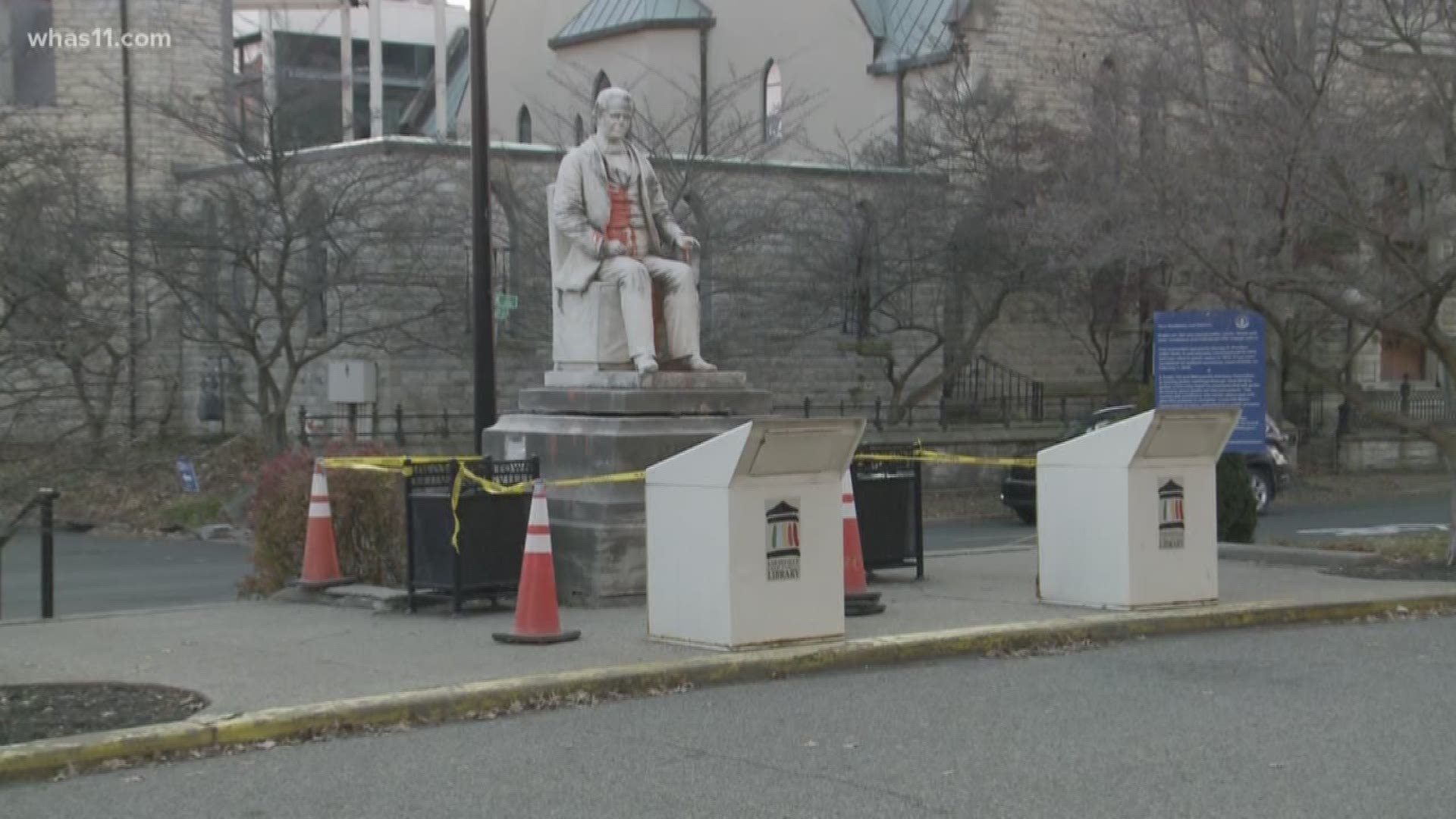The caution tape and cones are surrounding a statue with Confederate ties in downtown Louisville.