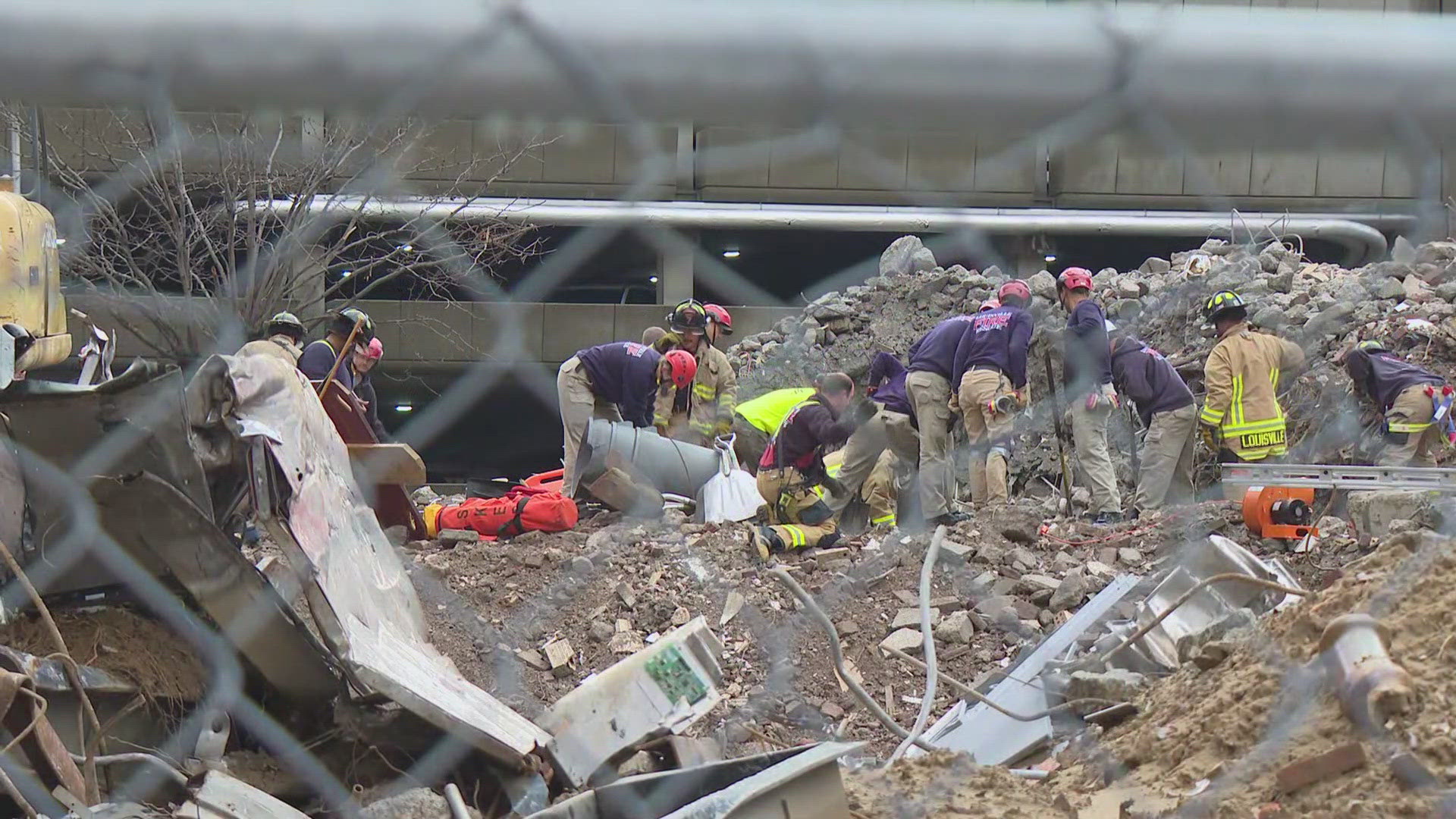 A construction worker is trapped in the rubble, but still communicating with firefighters.