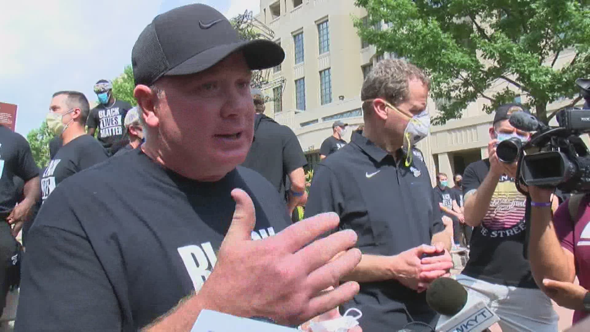 UK's football team, including coach Mark Stoops, participated in Lexington protests Friday.