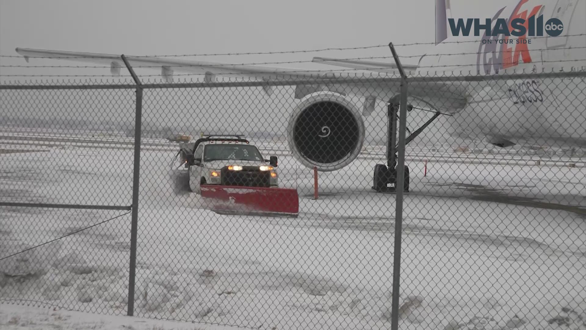 As heavy snow fell during the winter storm, workers at the airport removed snow by plows at the airport.