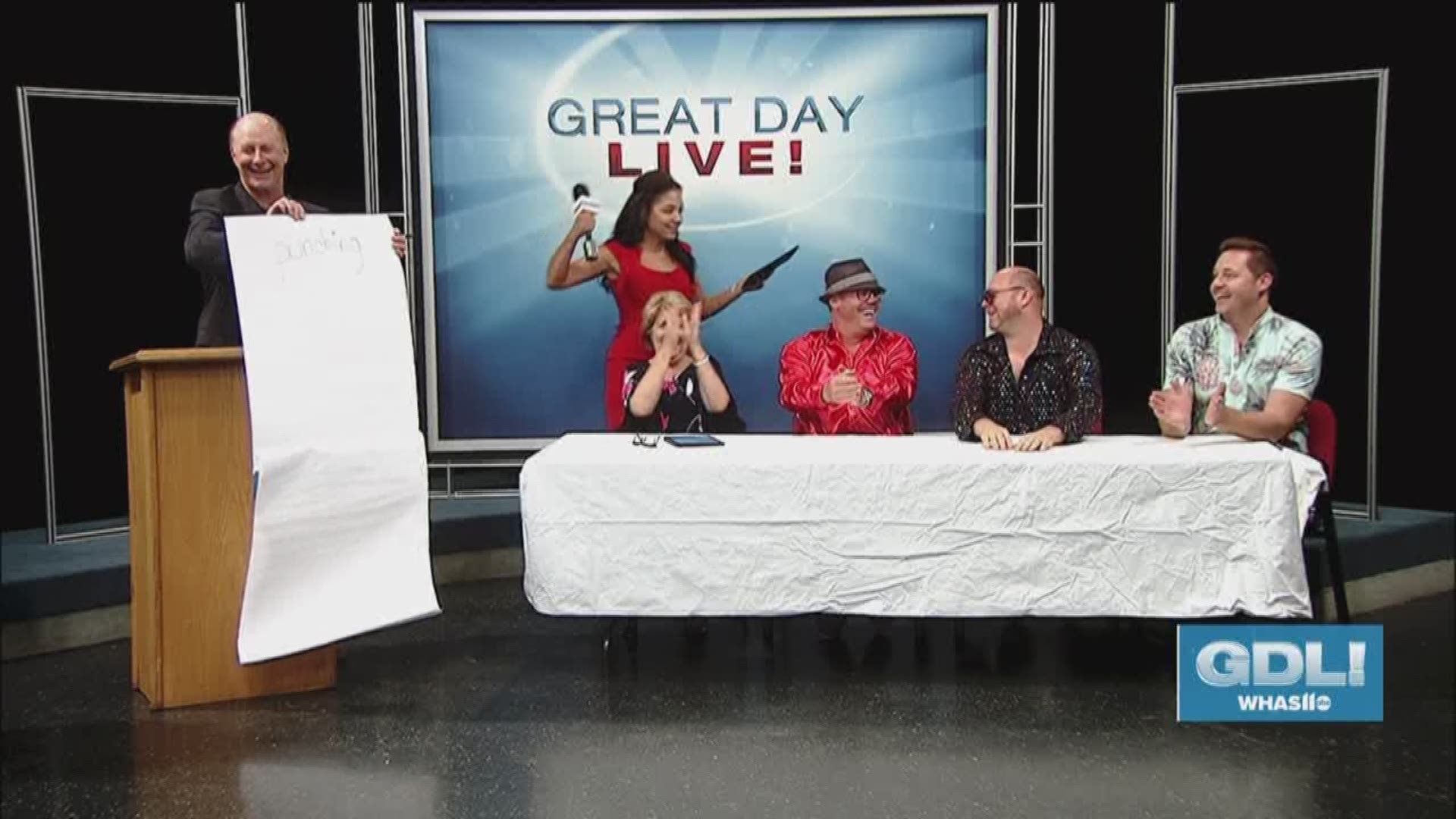 Angie Fenton practices her game show host skills on Terry, Rachel and friends in preparation for a charity event for The BreakAway in New Albany.