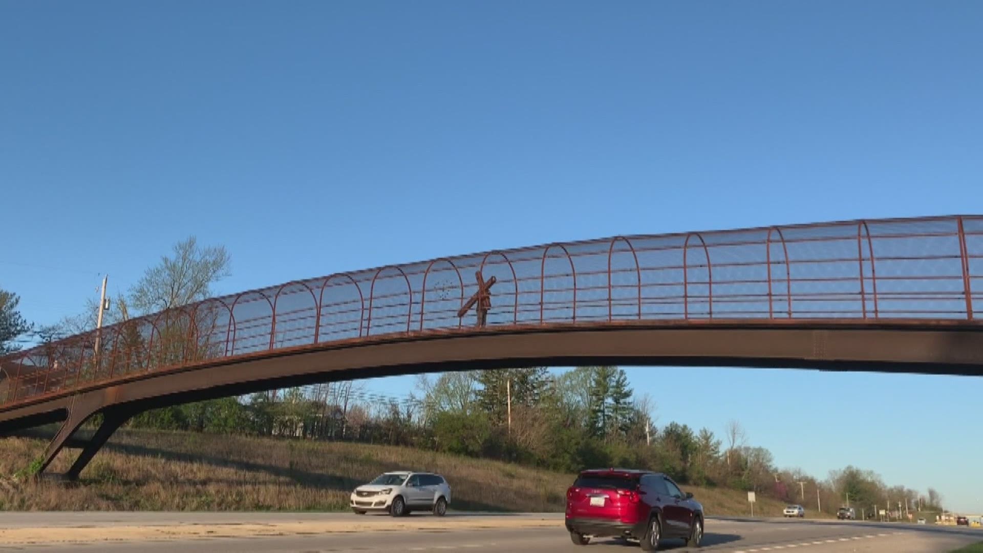 For one week every year, 75-year-old Larry Clark walks back and forth on the Arlington Bridge carrying a cross.