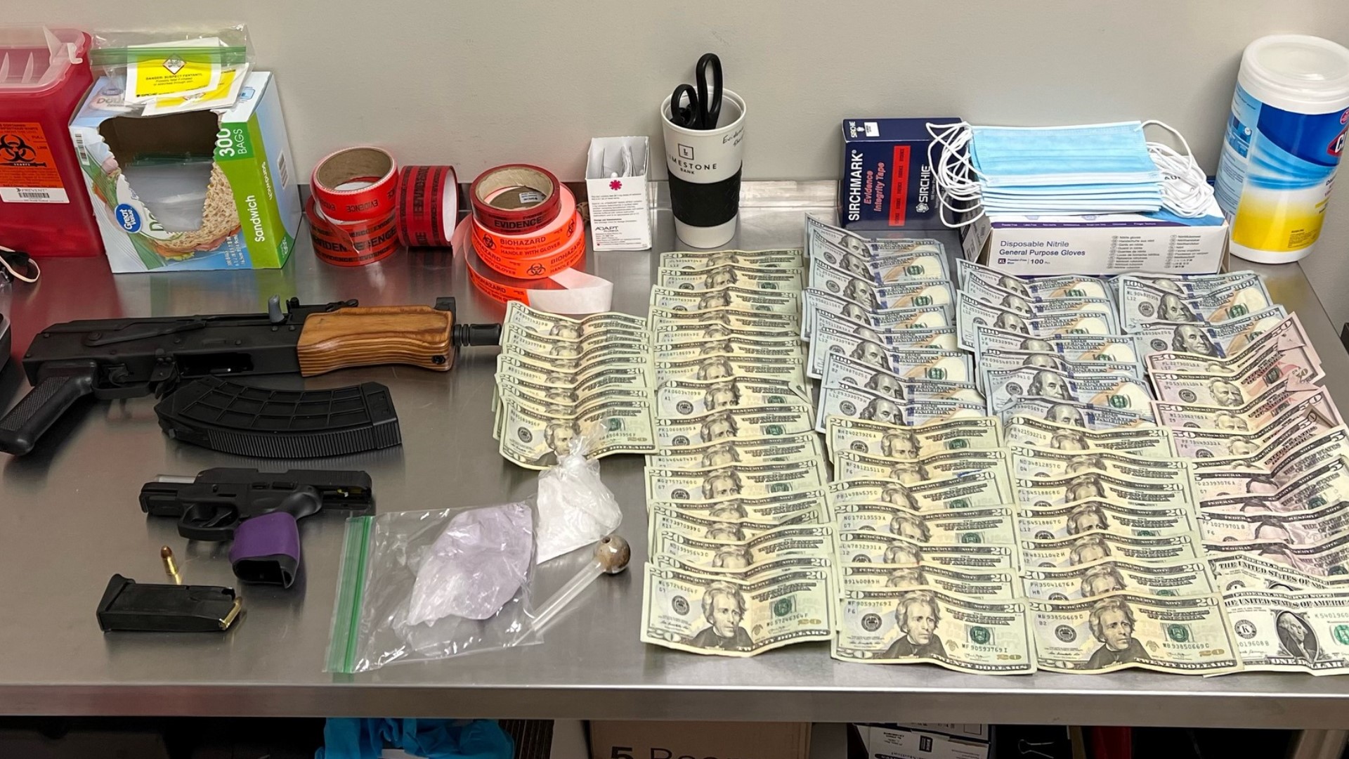 Police said officers found suspected meth, a powdered substance suspected of containing fentanyl, cash, two guns and a clear pipe.