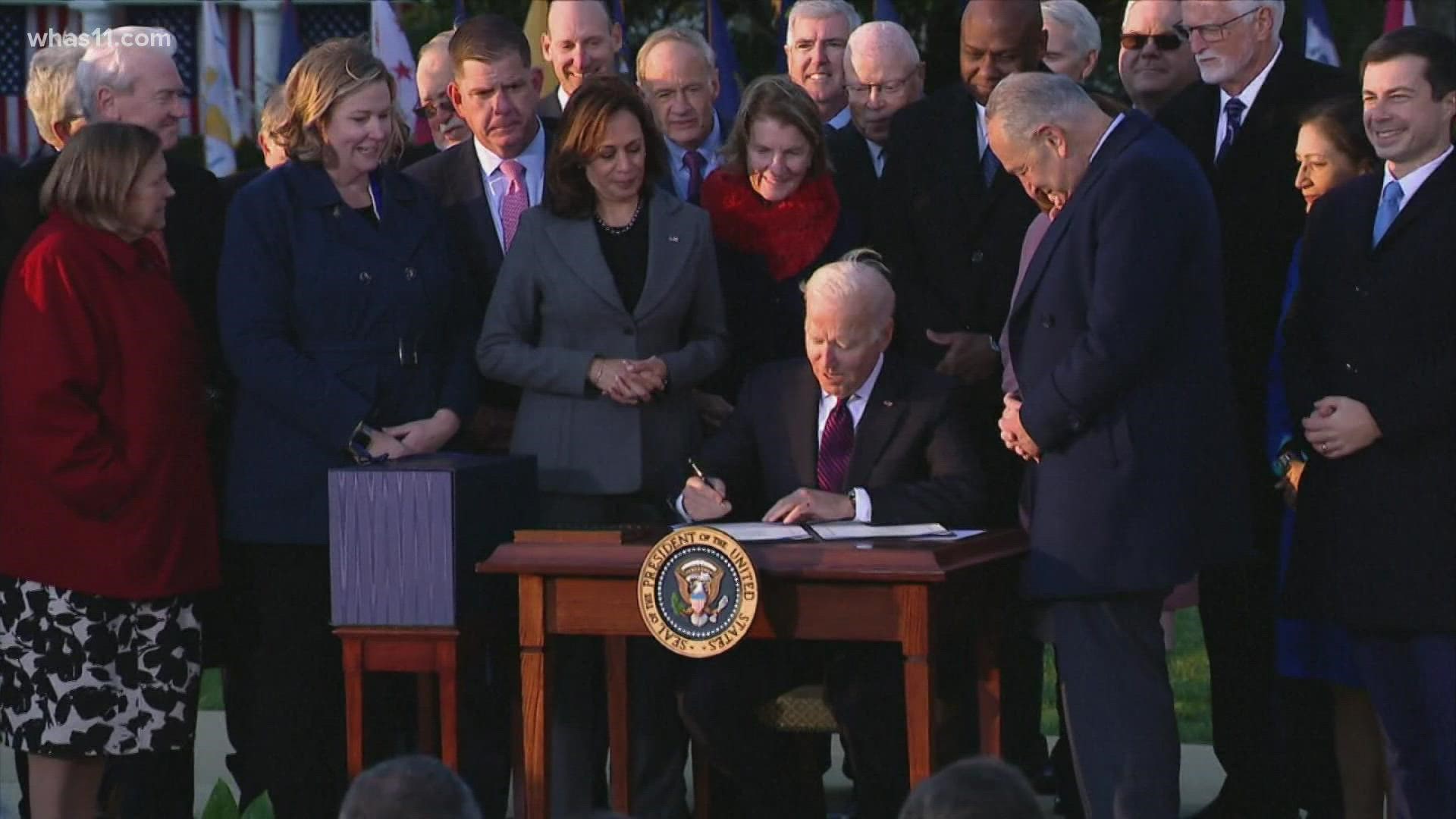 President Joe Biden signed his $1 trillion infrastructure deal into law Monday on the White House lawn, hailing it as an example of what bipartisanship can achieve.