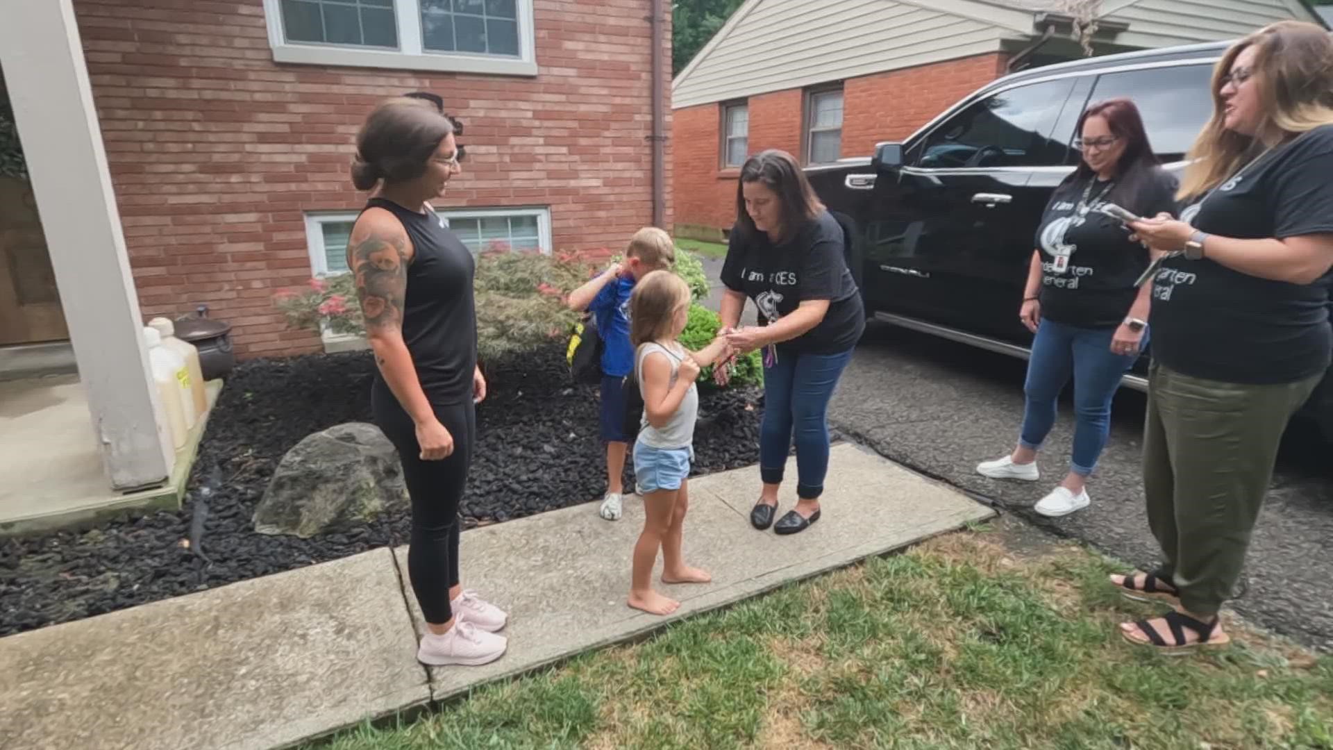 Teachers with Clarksville Schools stopped by the homes of nearly 70 randomly-selected students delivering school calendars, drawstring backpacks, and other gear.