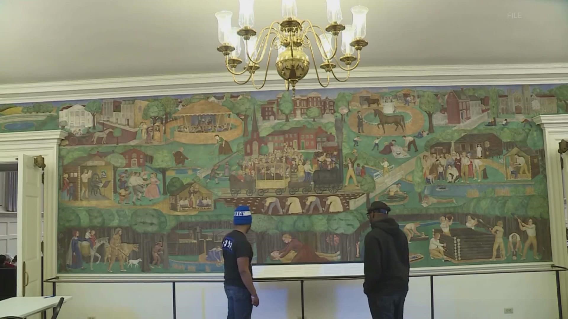 The mural illustrates the segregation of races by showing African Americans and Native American individuals working on farmland.