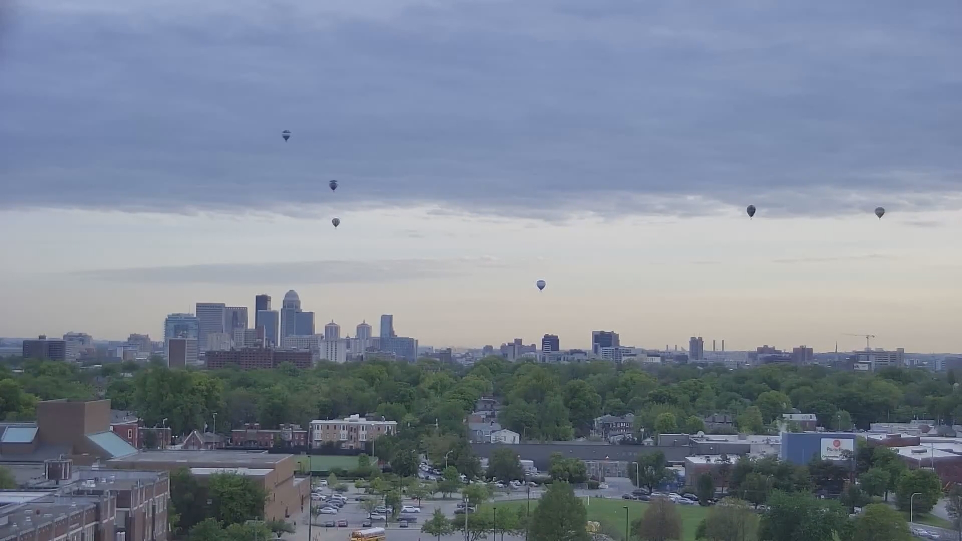 Several hot air balloons fly past the Louisville skyline for the Kentucky Derby Festival's Great Balloon Race on April 26, 2024.