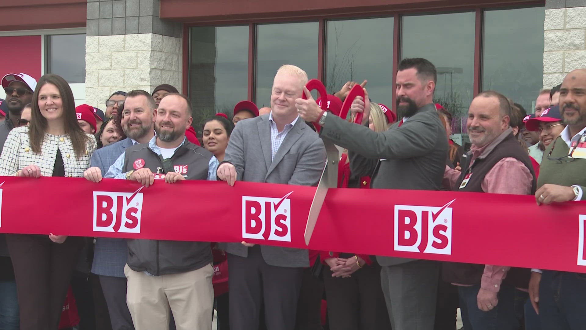 The retailer celebrated early by having a ribbon cutting on Thursday.
