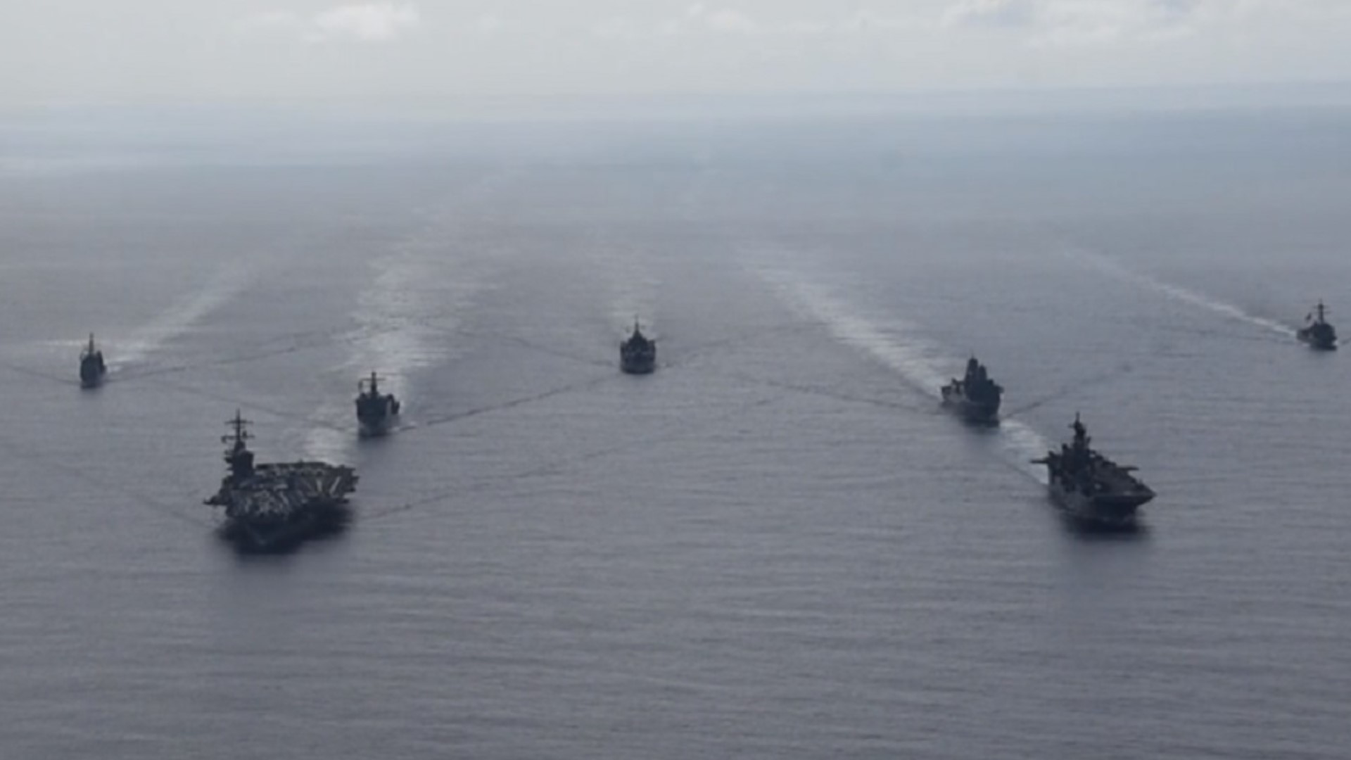 Ships from the Theodore Roosevelt Carrier Strike Group, the America Expeditionary Strike Group, and the U.S. 7th Fleet command ship, USS Blue Ridge in formation.
