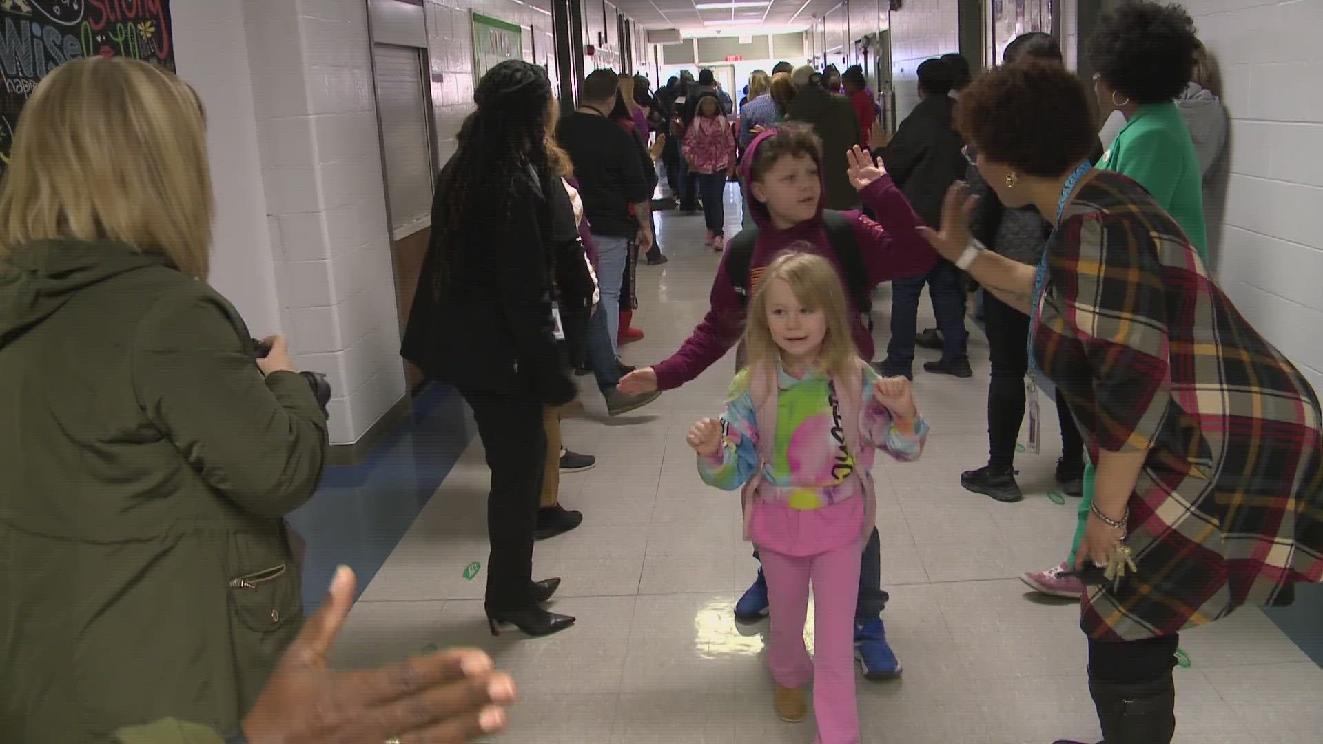 Dozens of women from across the community were at Shacklette Elementary School handing out high fives, cheering, and encouraging students.