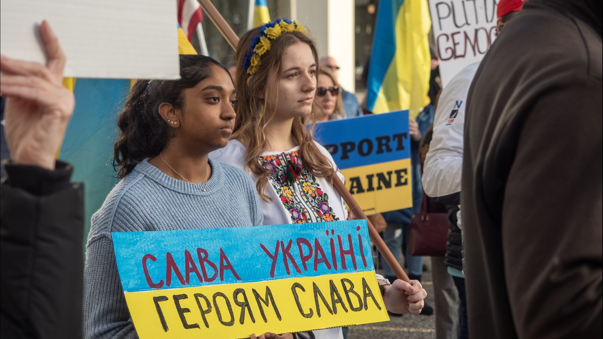 Dozens of people carried signs that sent a stark reminder to anyone who may have forgotten the ongoing year-long war.