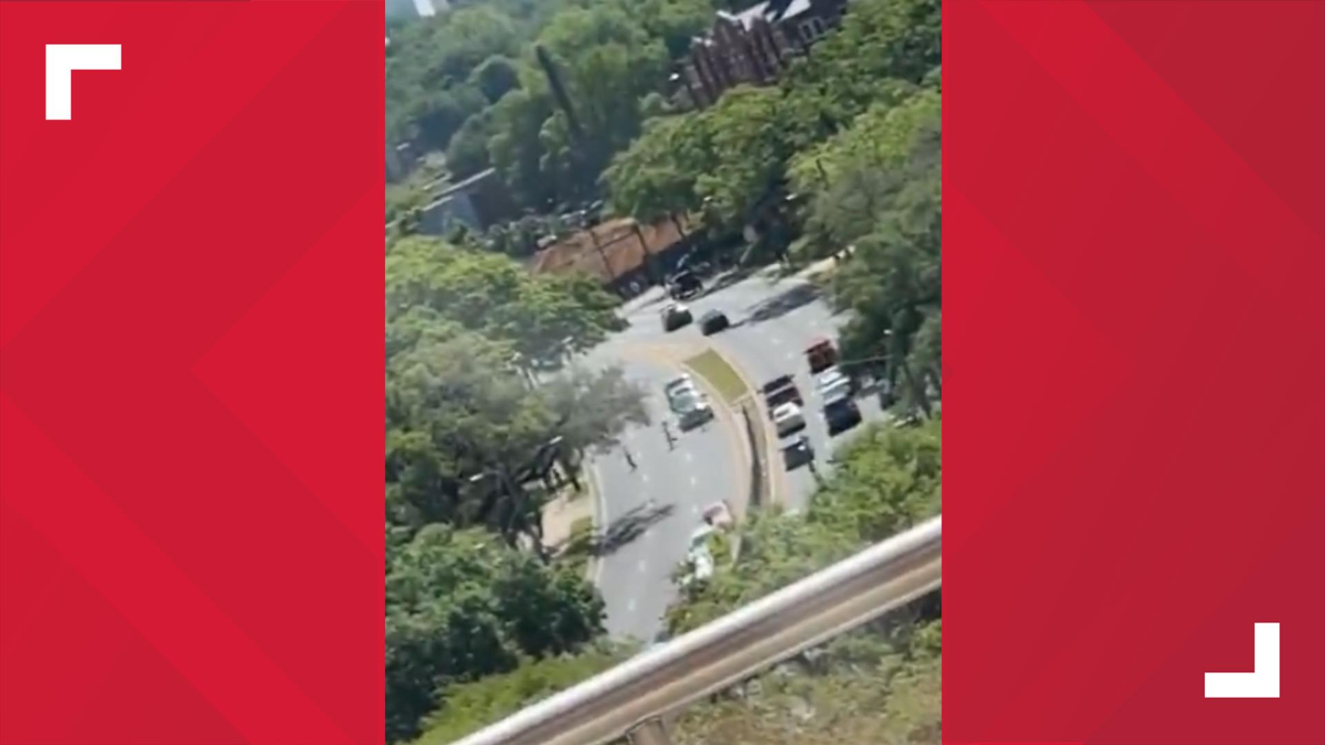 People run across a road in Tallahassee. Six people have been hospitalized with one in critical condition. A suspect is in custody. (Garrett Harvey)
